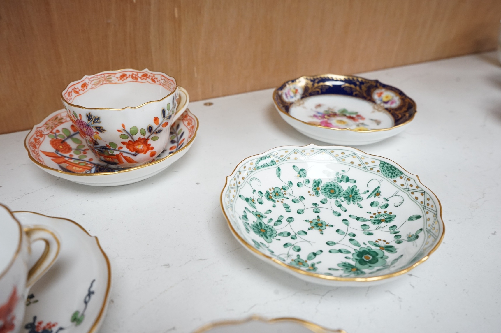 A collection of Meissen cabinet cups and saucers and four knife rests. Condition - varies